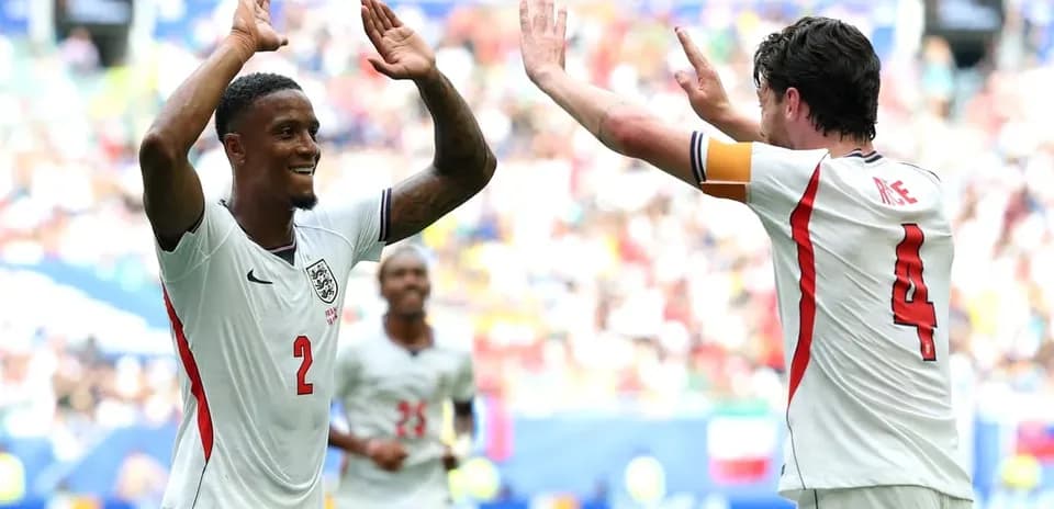 Two England players celebrating a goal on field