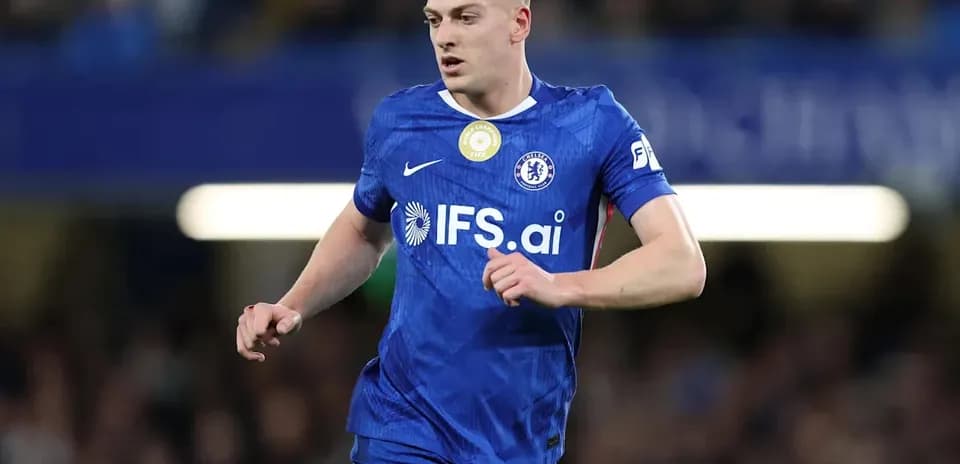 Player in blue Chelsea kit running on the pitch