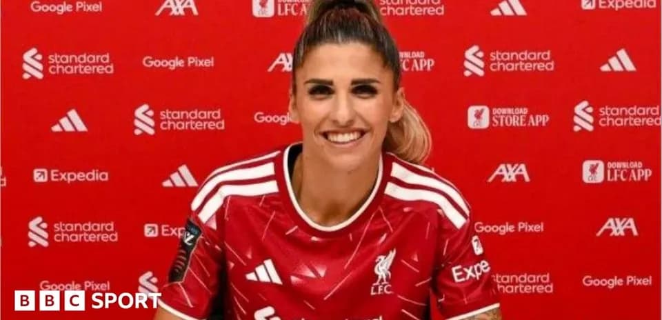 Player in Liverpool jersey at press conference