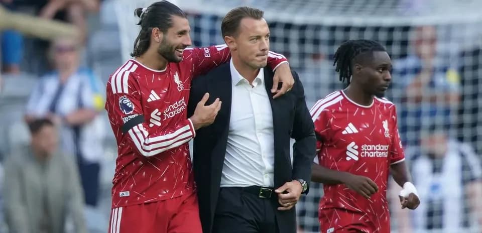 Liverpool players celebrating with coach after match