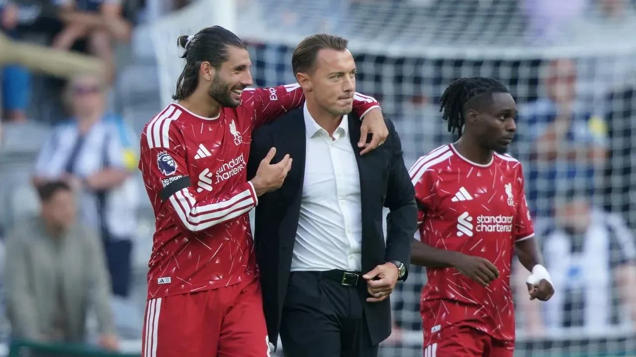 Liverpool players celebrating with coach after match