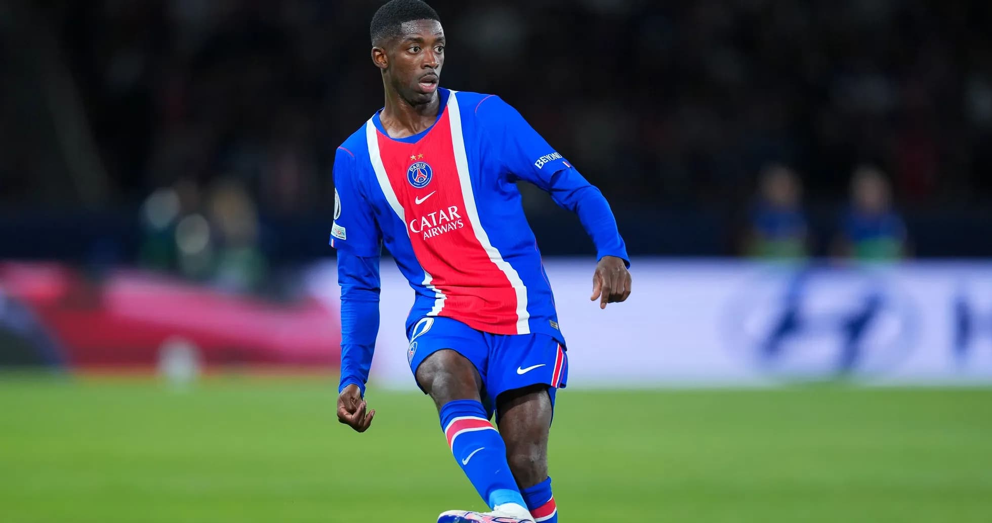 Player in PSG kit dribbling during match