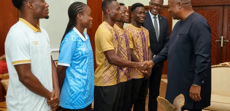 Athletes shaking hands with official in meeting