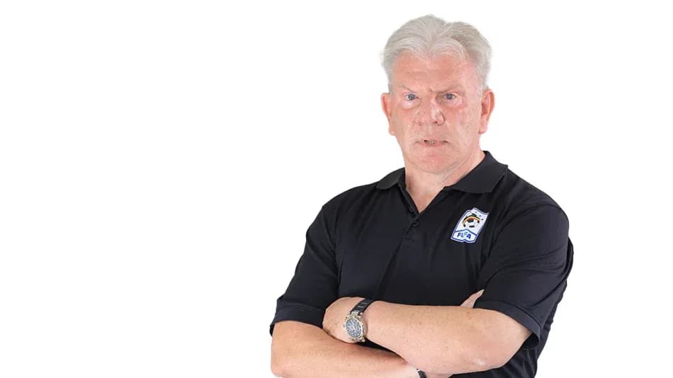 Man with arms crossed wearing a black polo shirt