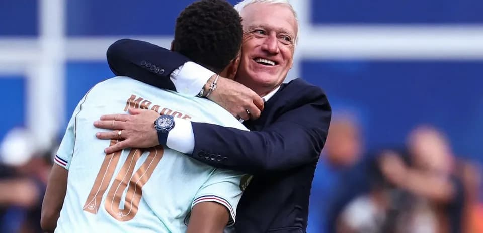 Player and coach celebrating with a hug