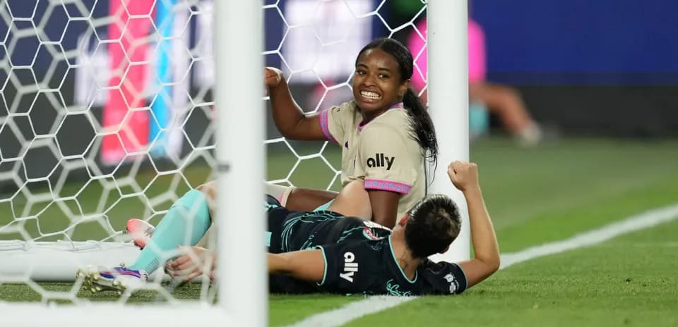 Players celebrating near the goal during match