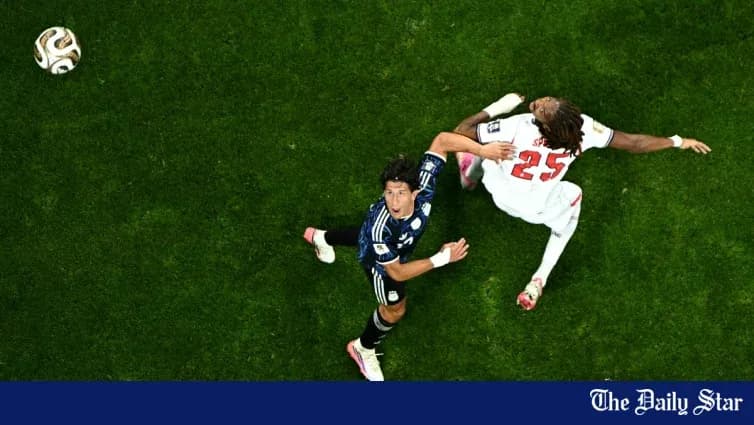 Player kicking ball while opponent falls during match