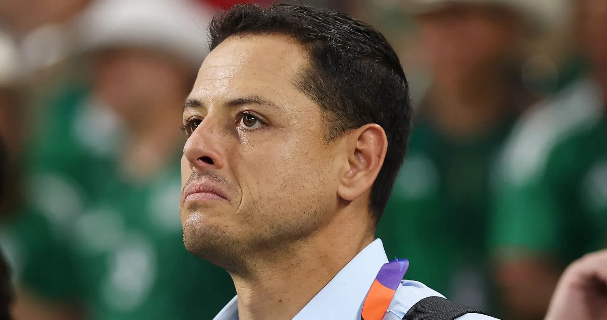 Player with tears watching the match in background