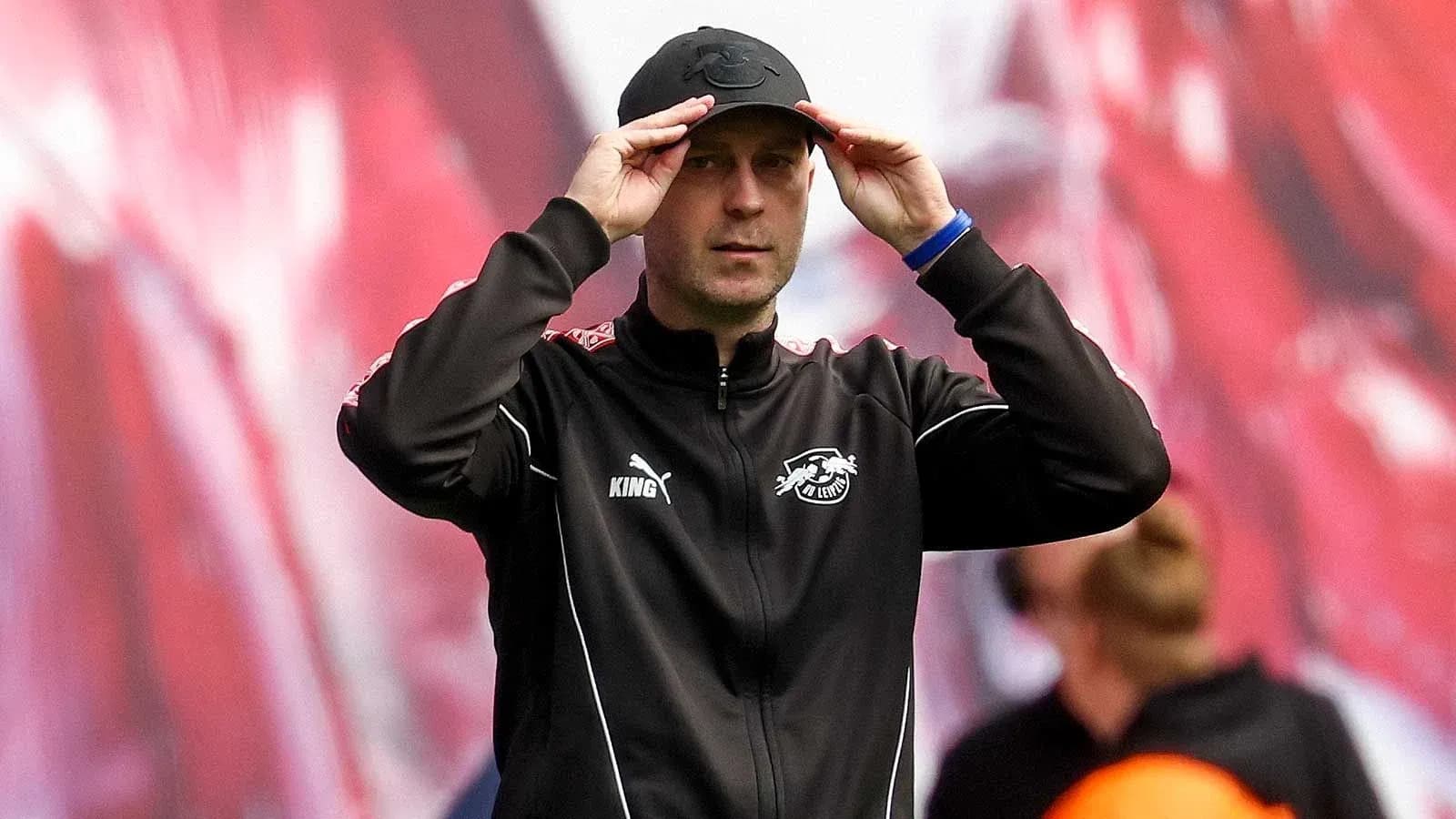 Coach adjusting cap during match on the sidelines