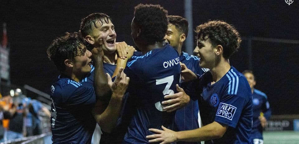 Players celebrating a goal during match