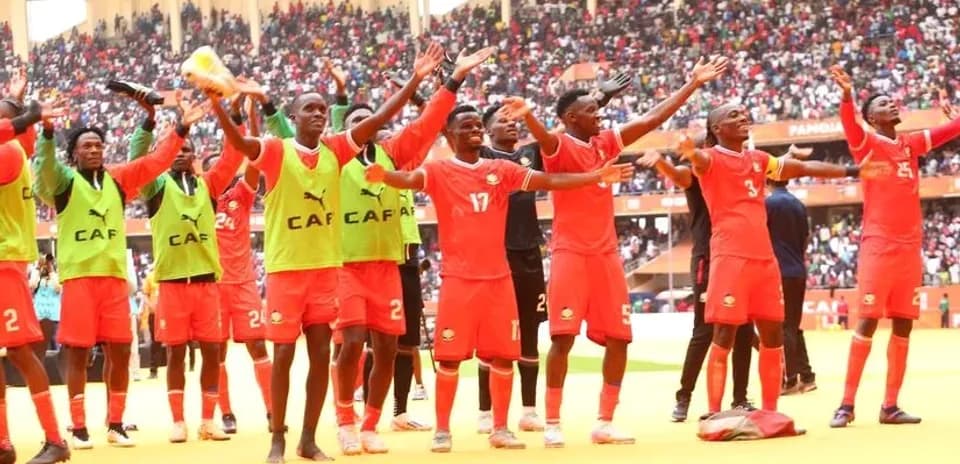 Players celebrating in front of cheering crowd