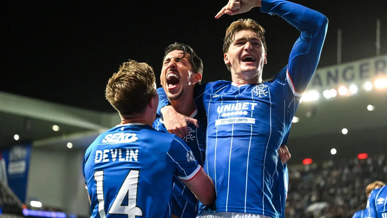 Rangers players celebrating a goal in blue jerseys