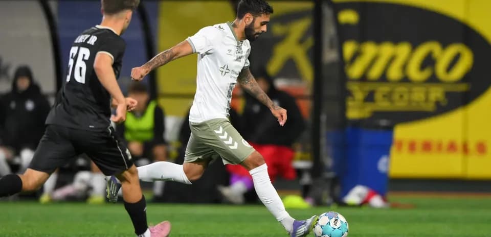 NY Cosmos player dribbling past Hartford Athletic opponent