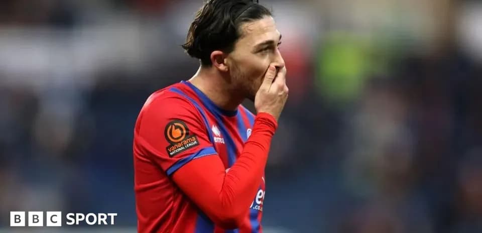 Player in red jersey showing concern during match