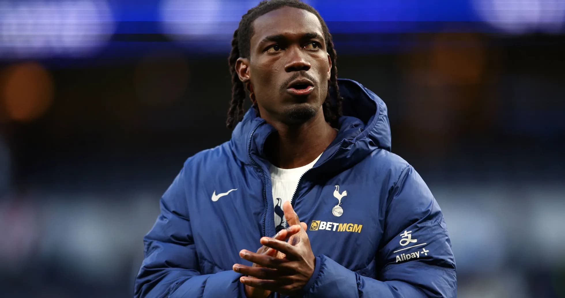 Player in Tottenham jacket warming up before match