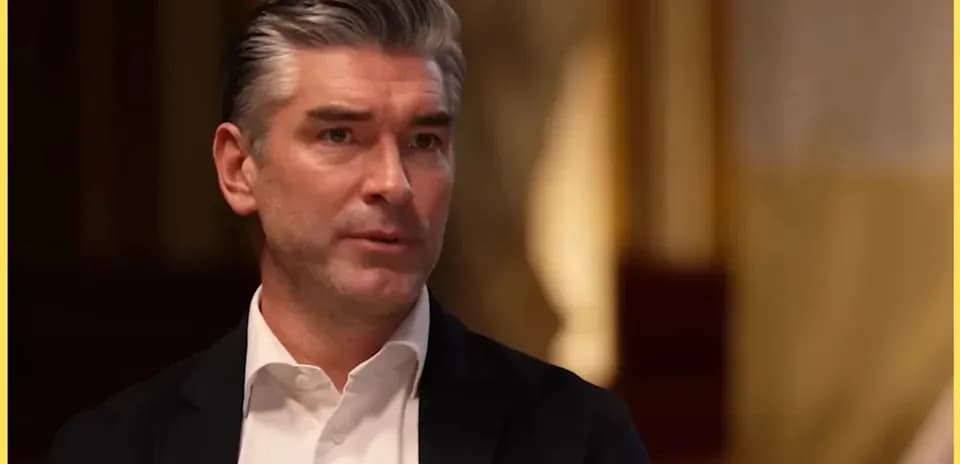 Man speaking during an interview in a formal setting