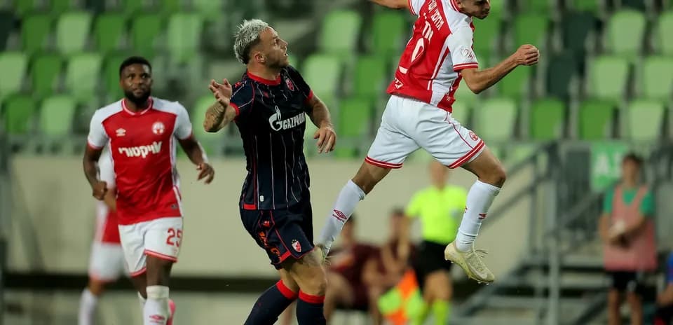 Crvena Zvezda player heading the ball during match
