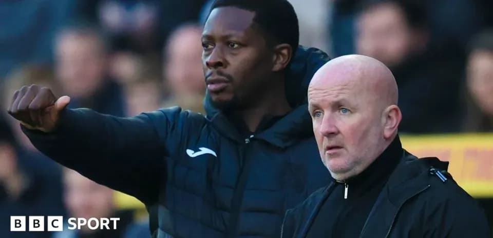 Coaches discussing tactics during a match
