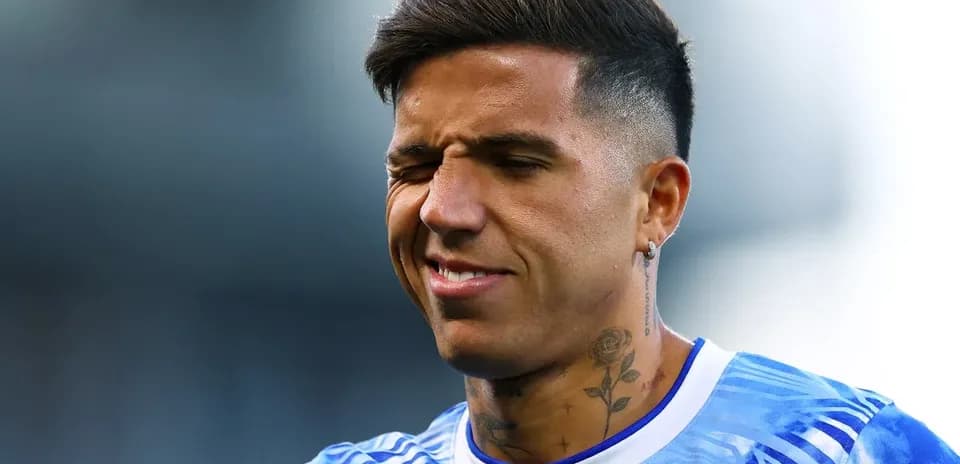 Player in blue jersey squinting during warm-up