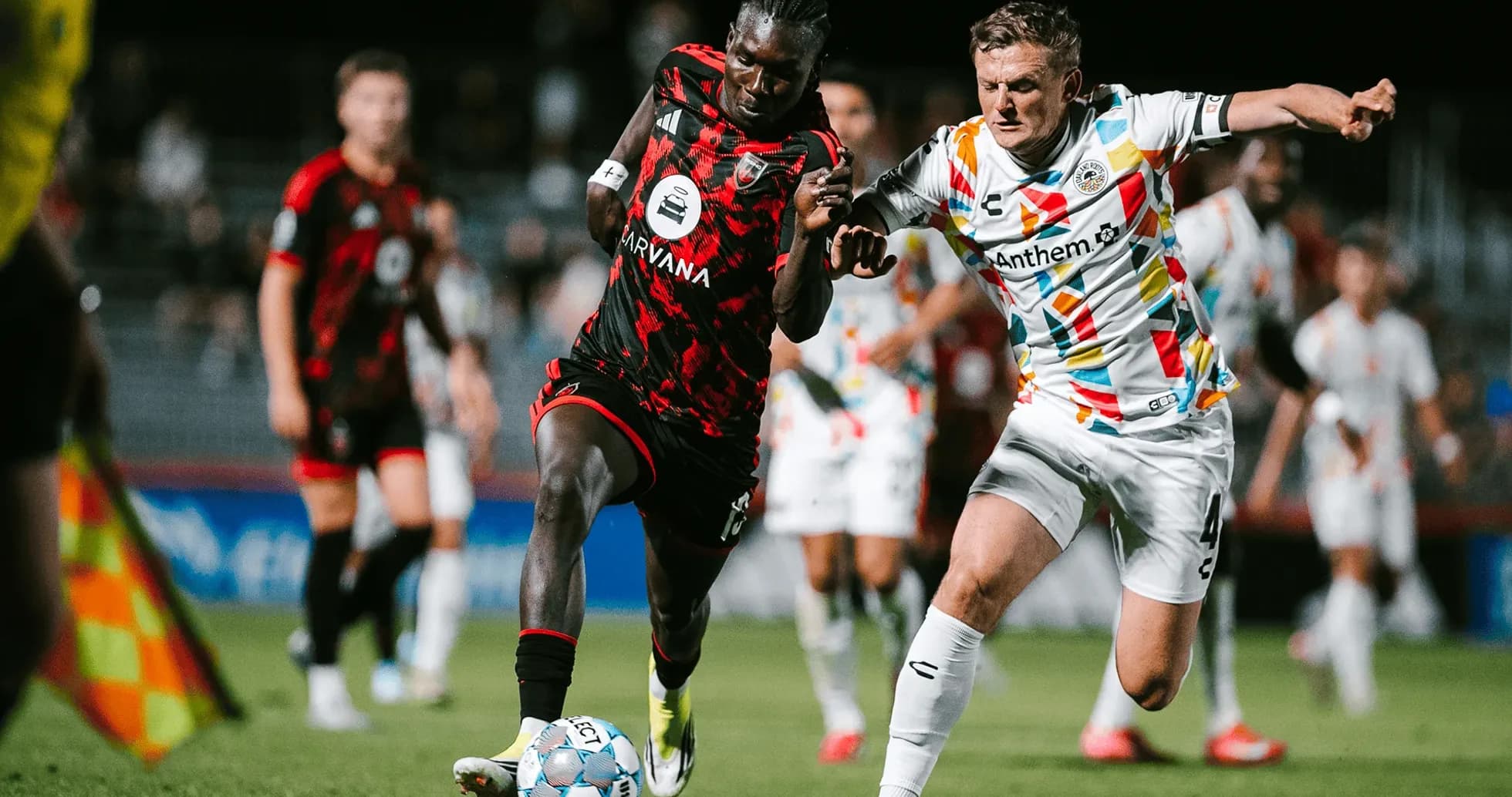 Players competing for the ball during match