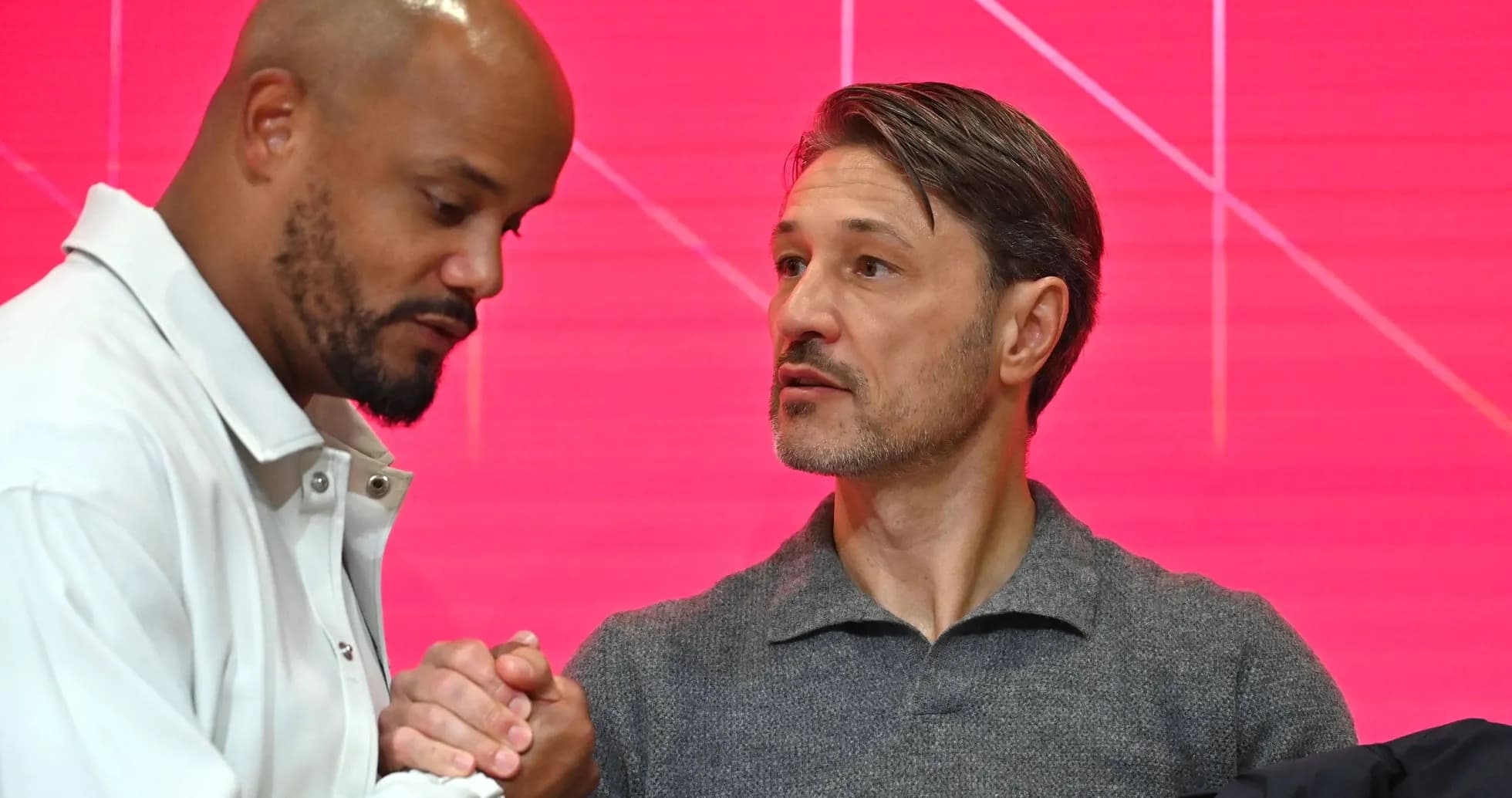 Two men shaking hands during a press event