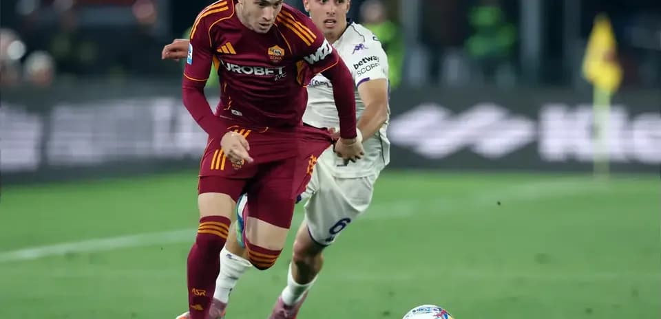Player sprinting with ball, opponent chasing during match