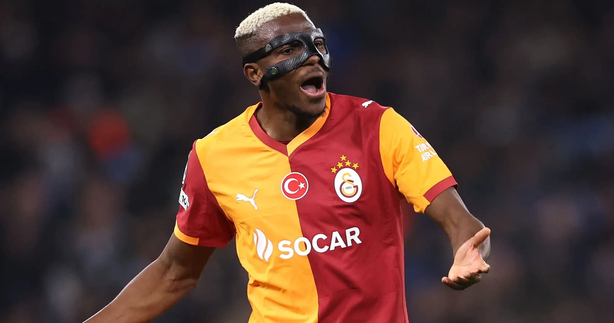 Player celebrating in Galatasaray jersey with mask