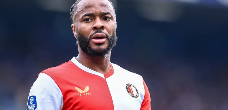 Feyenoord player in red and white jersey on field