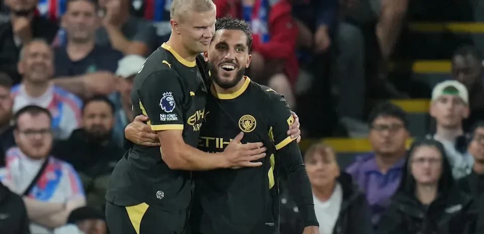 Two Manchester City players celebrating a goal