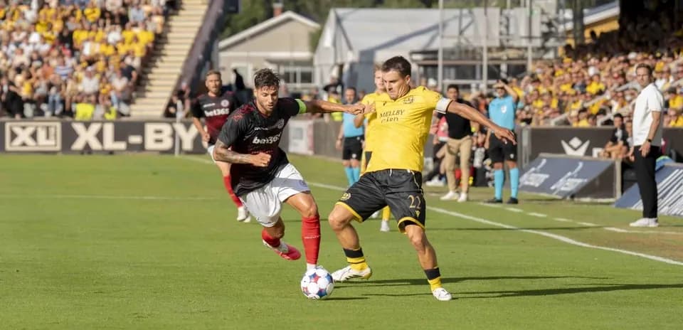 Players competing for the ball in football match