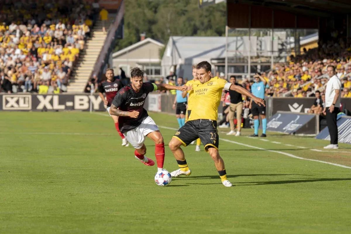 Players competing for the ball in football match