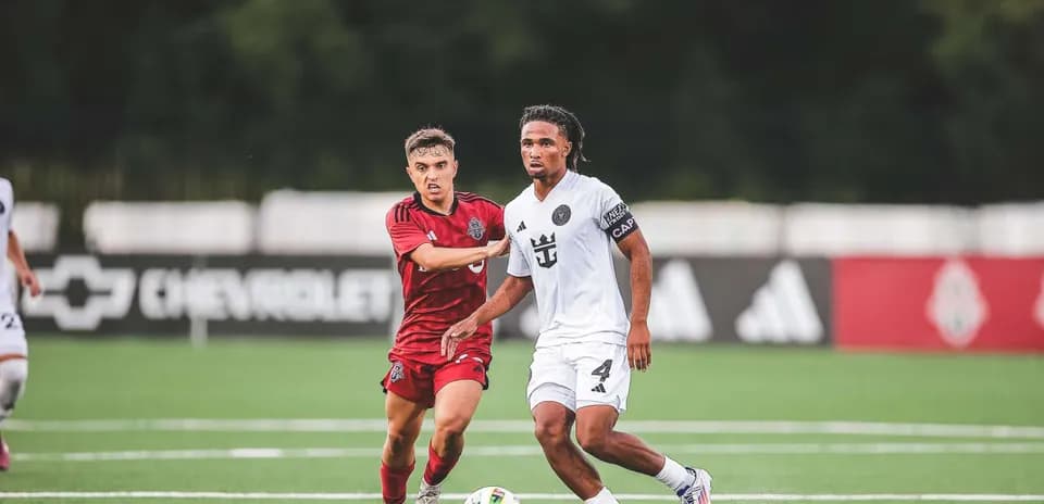 Inter Miami II player dribbling past Toronto II opponent