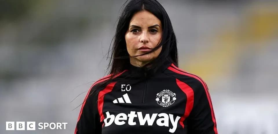 Coach wearing Manchester United training gear on field