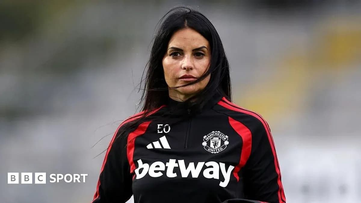 Coach wearing Manchester United training gear on field