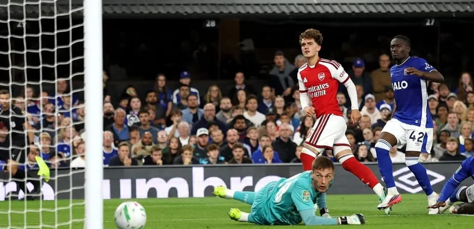 Arsenal player celebrating after scoring against opponent