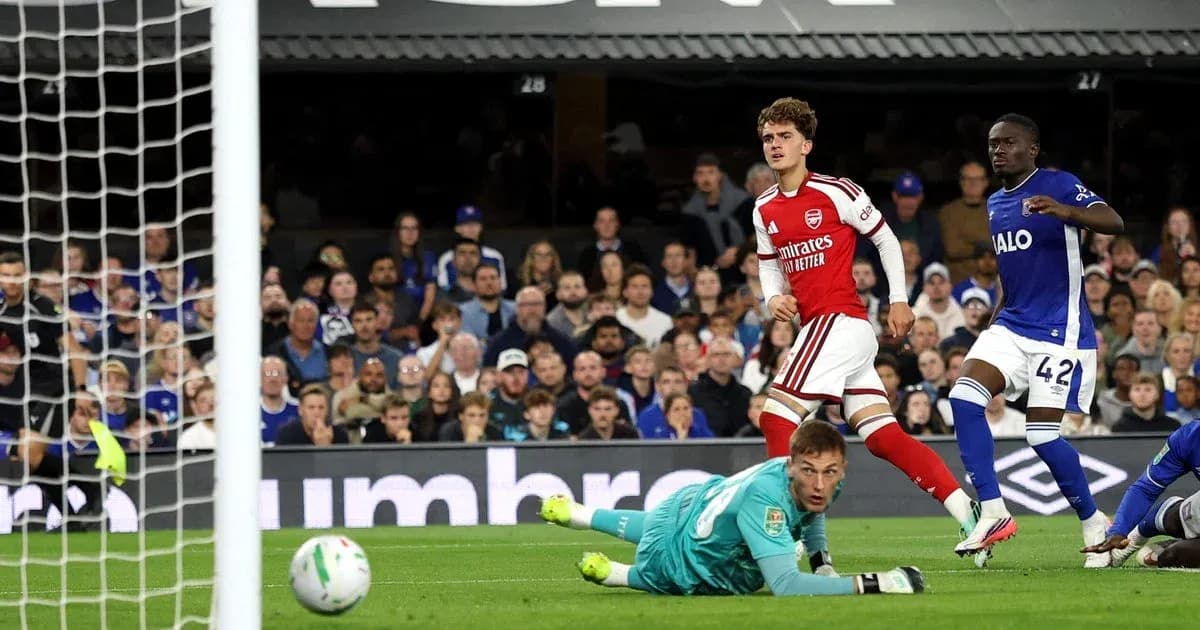 Arsenal player celebrating after scoring against opponent