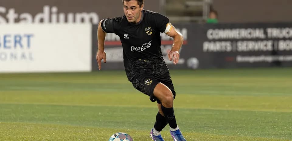 Player in black jersey dribbling the ball