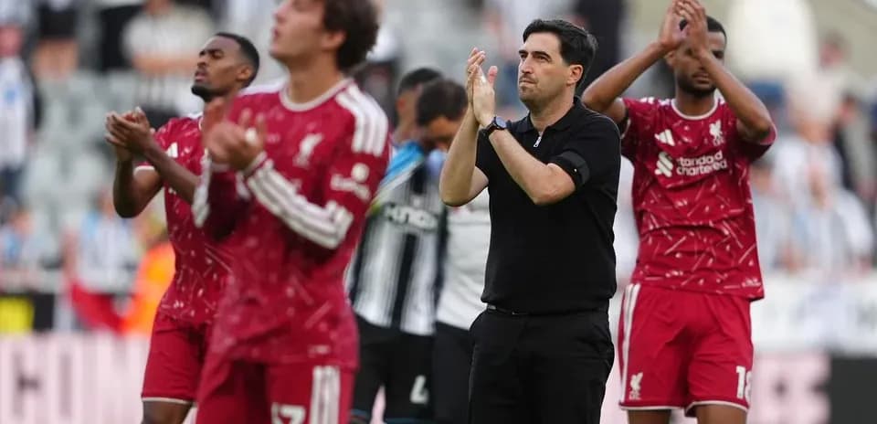 Liverpool players and manager applauding fans post-match