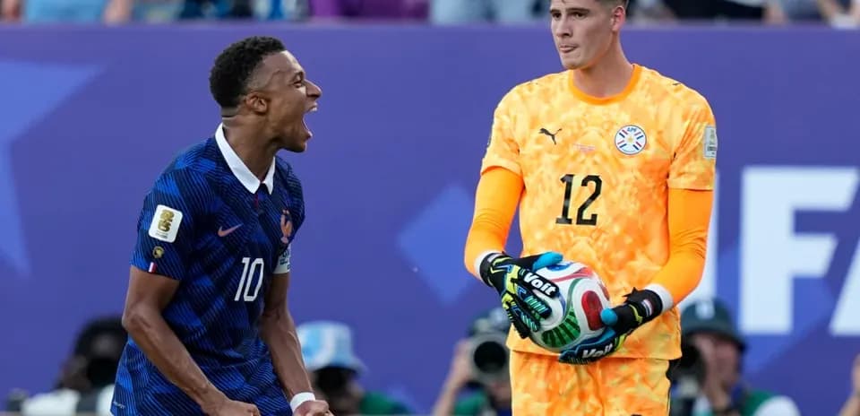 French player celebrating near Paraguayan goalkeeper during match