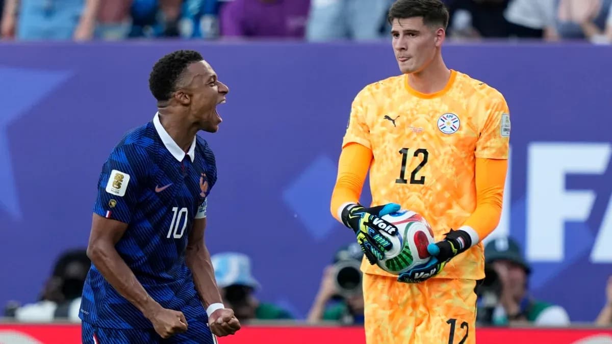 French player celebrating near Paraguayan goalkeeper during match