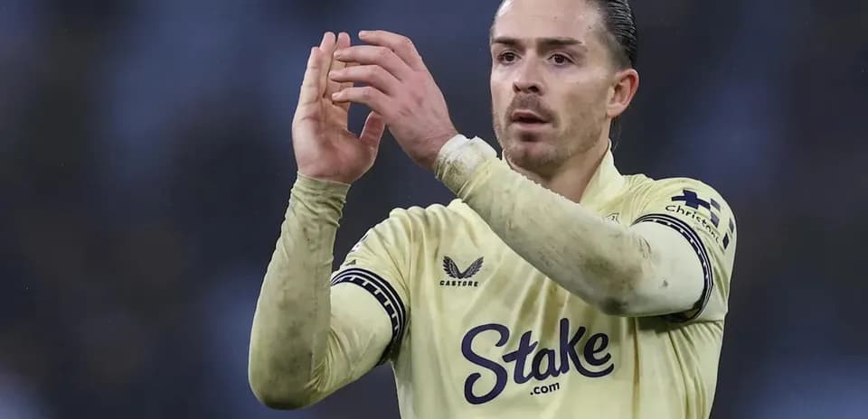 Player applauding fans while wearing team jersey