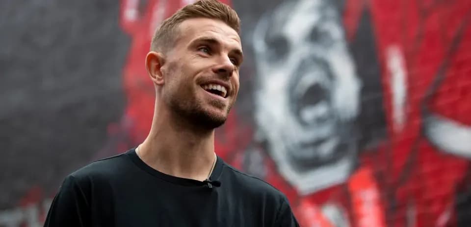 Player smiling in front of mural background