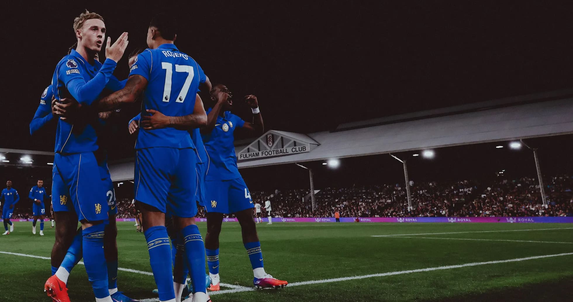 Players celebrating a goal at Fulham stadium