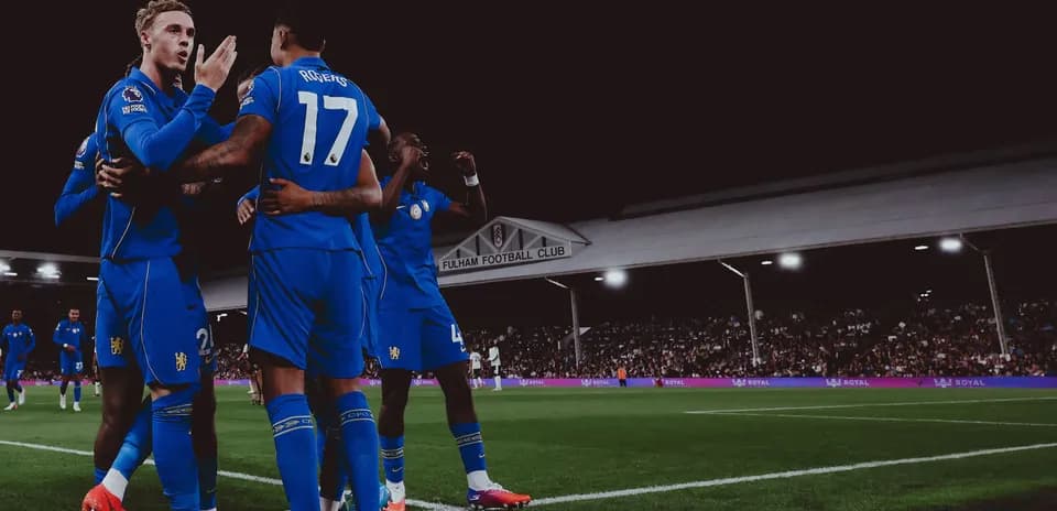 Players celebrating a goal at Fulham stadium