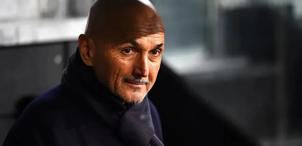 Coach in a dark coat looking intently