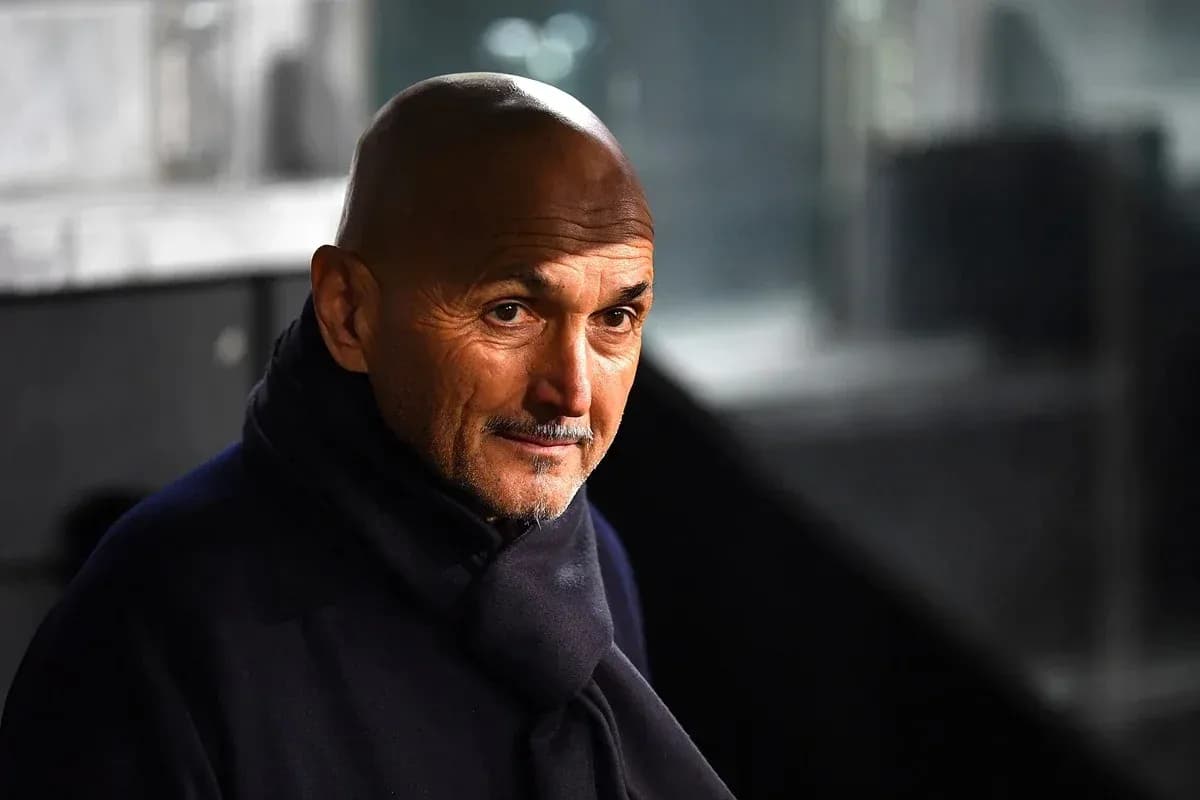 Coach in a dark coat looking intently