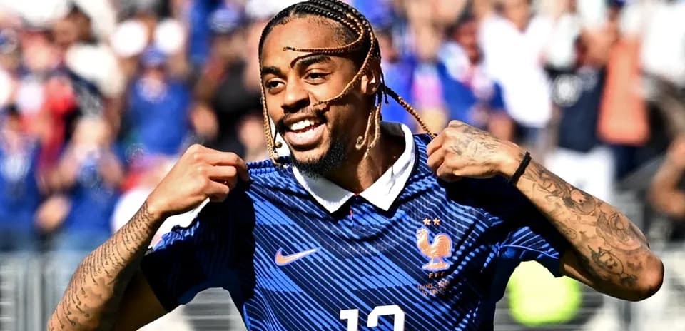 Player celebrating and showing jersey after scoring