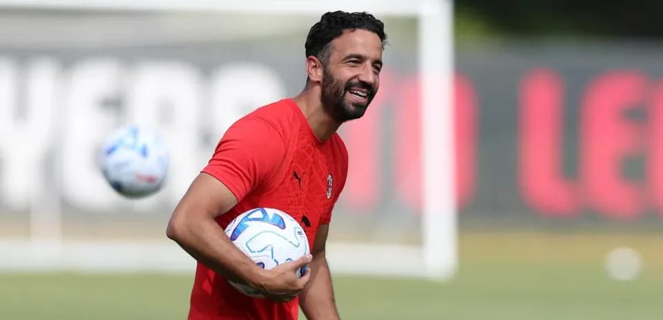 Coach holding soccer balls during training session