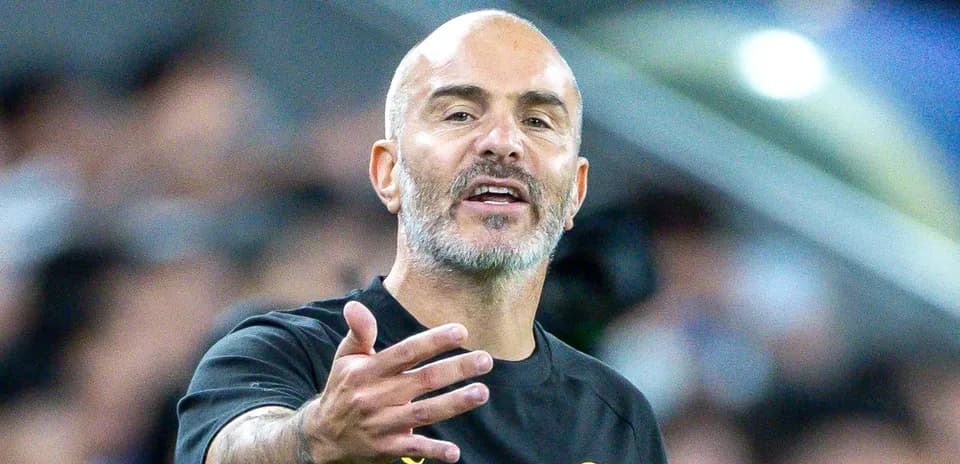 Manager gesturing during a match on the sideline