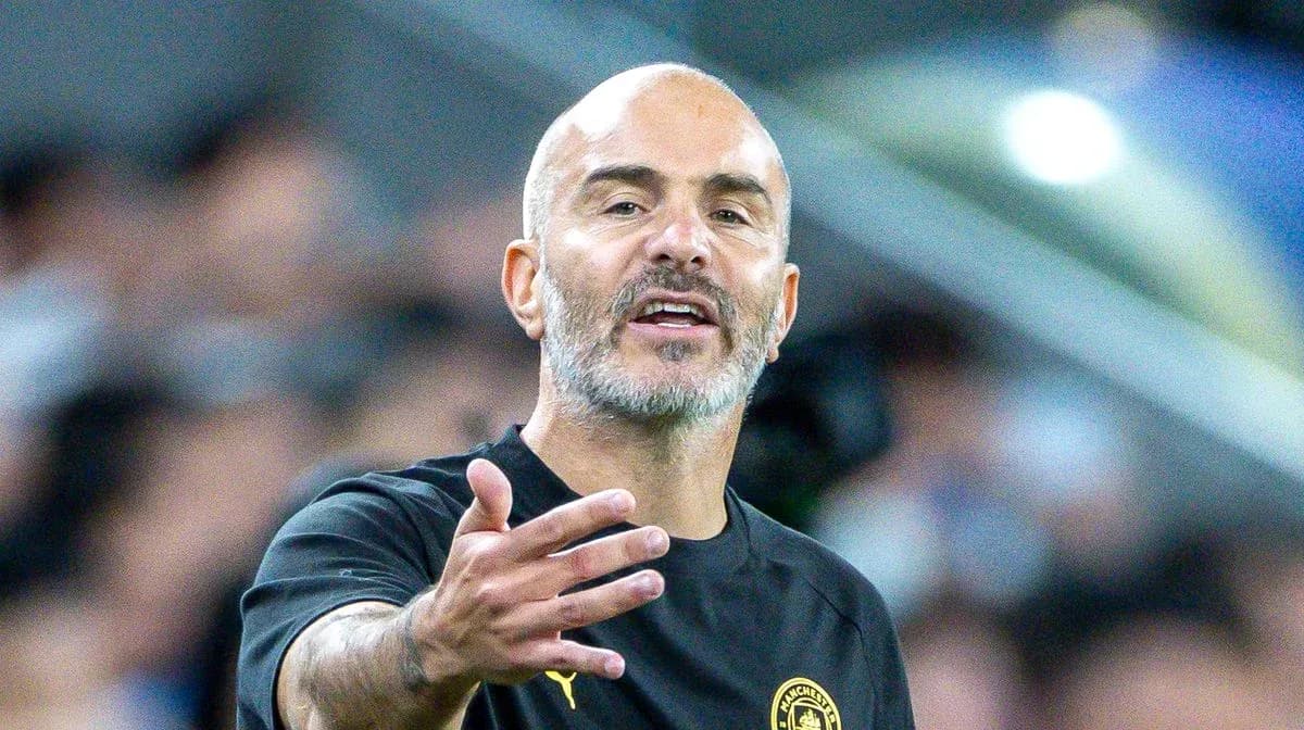 Manager gesturing during a match on the sideline
